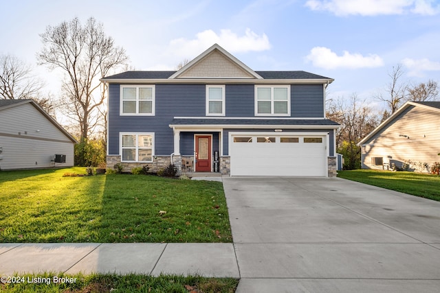 view of front of home with a front lawn and a garage