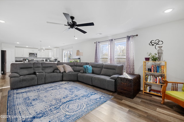 living room featuring hardwood / wood-style flooring and ceiling fan