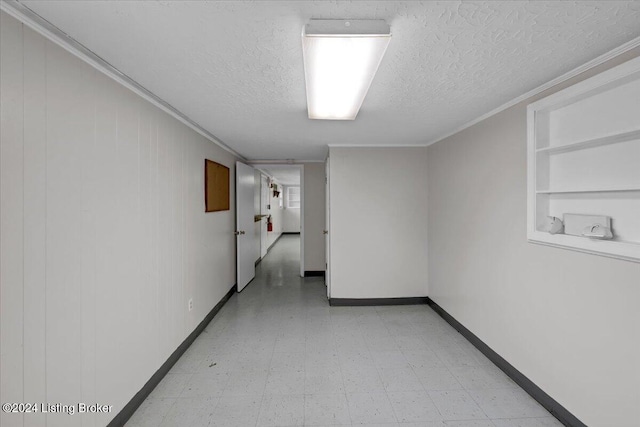 hall featuring a textured ceiling, built in features, and ornamental molding