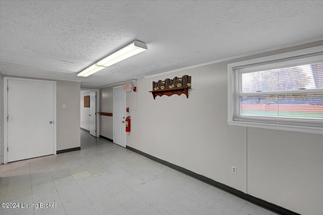 empty room featuring crown molding and a textured ceiling