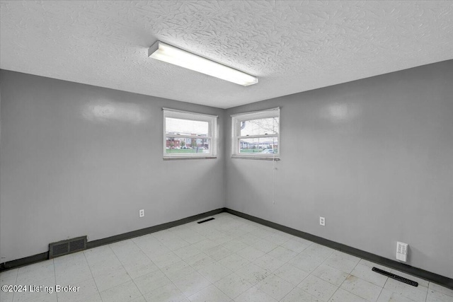 spare room featuring a textured ceiling