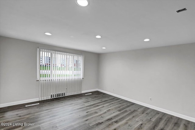 unfurnished room with dark hardwood / wood-style flooring