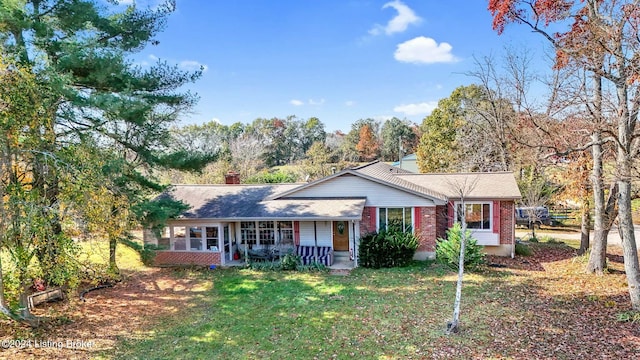 ranch-style house featuring a porch and a front yard