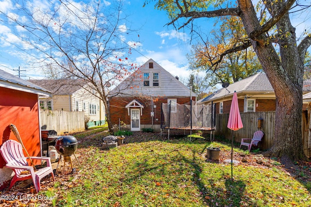 back of property featuring a trampoline