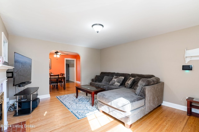 living room with ceiling fan and light wood-type flooring