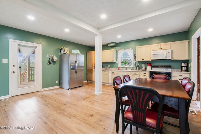 dining space featuring light wood-type flooring