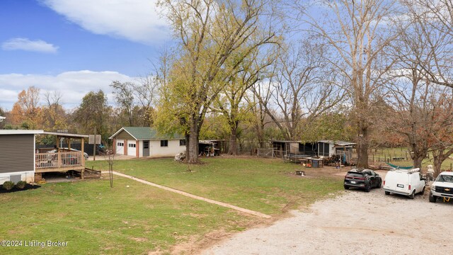 view of yard featuring a wooden deck and an outbuilding