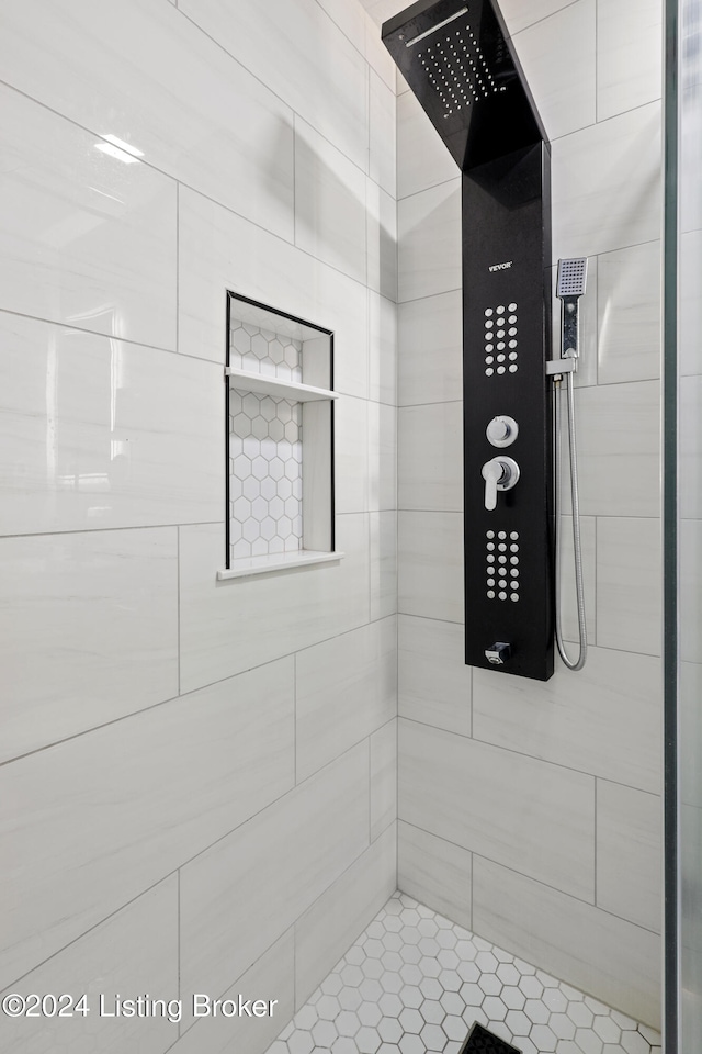 bathroom with a tile shower