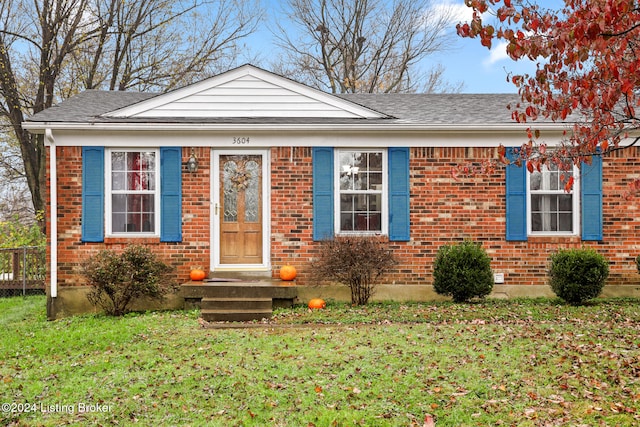 bungalow-style home with a front lawn