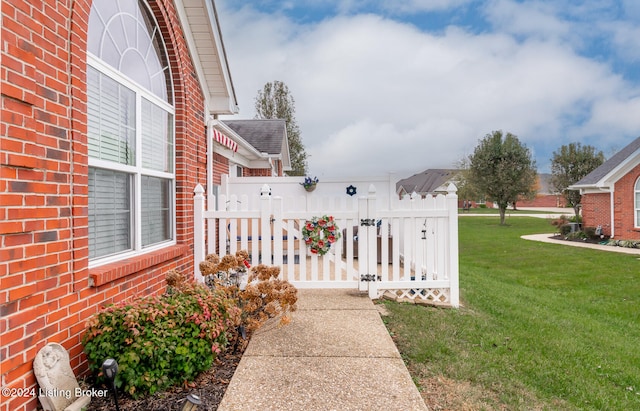 view of gate featuring a lawn