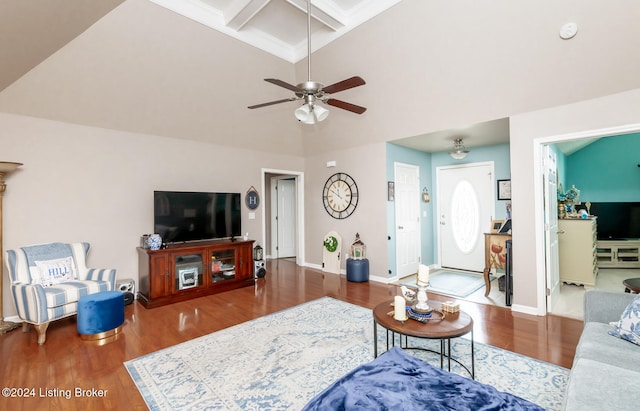 living room featuring hardwood / wood-style floors, ceiling fan, beamed ceiling, and coffered ceiling