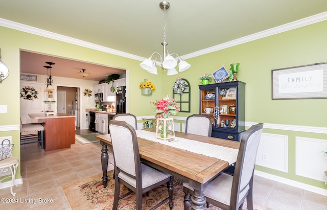 tiled dining room featuring crown molding and a notable chandelier