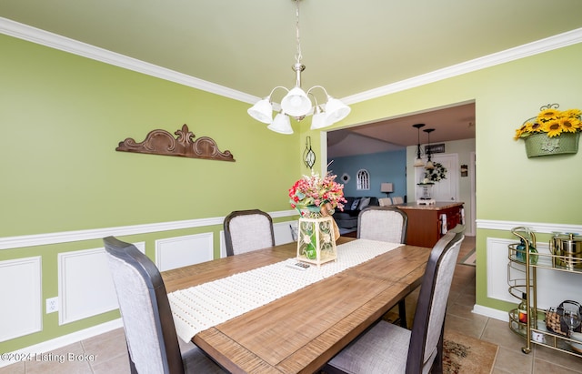 dining area featuring crown molding, tile patterned flooring, and a notable chandelier