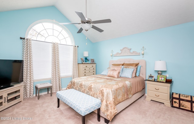 carpeted bedroom with ceiling fan and lofted ceiling