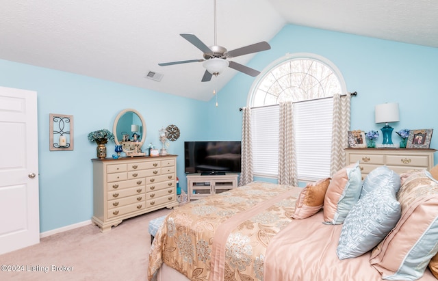 bedroom with ceiling fan, light carpet, and vaulted ceiling