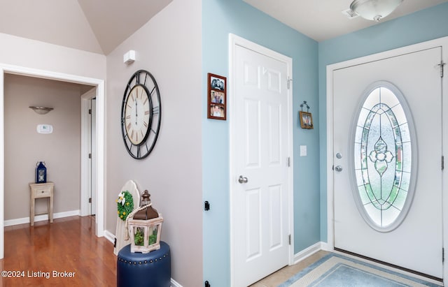 foyer featuring hardwood / wood-style flooring and lofted ceiling