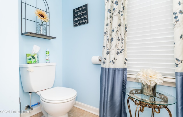 bathroom with tile patterned flooring and toilet