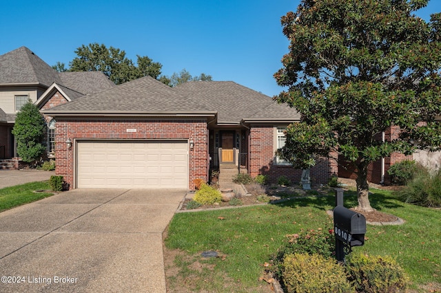 view of front of property featuring a front yard and a garage