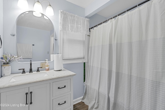 bathroom with a shower with shower curtain, vanity, and hardwood / wood-style flooring