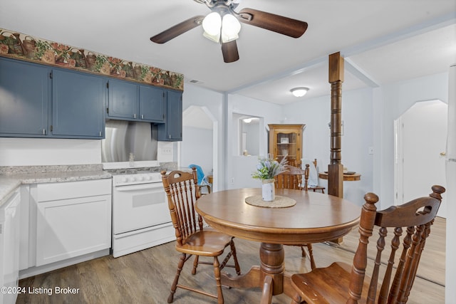 dining space with hardwood / wood-style flooring and ceiling fan