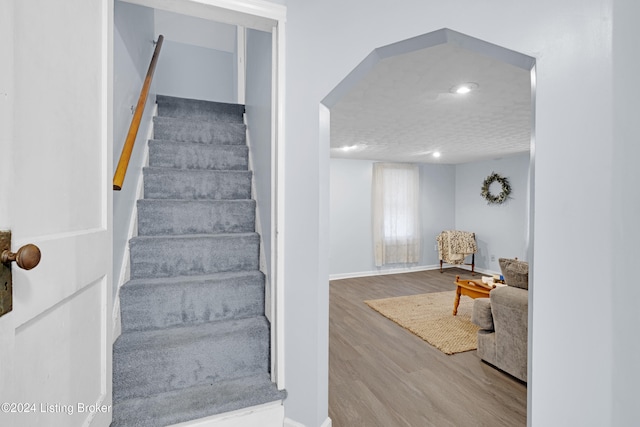 stairs featuring hardwood / wood-style flooring