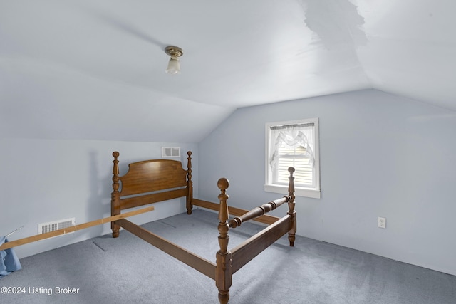 carpeted bedroom featuring lofted ceiling