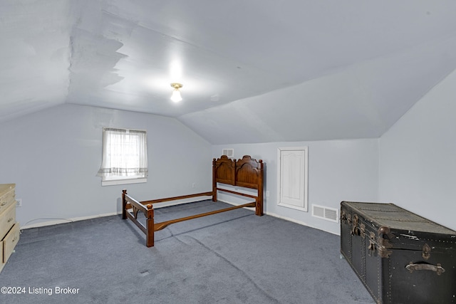 carpeted bedroom with vaulted ceiling