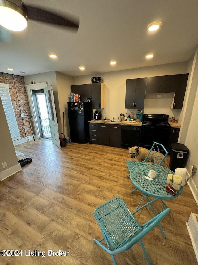 kitchen featuring black appliances and light hardwood / wood-style floors