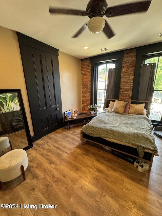 bedroom with light hardwood / wood-style floors and ceiling fan