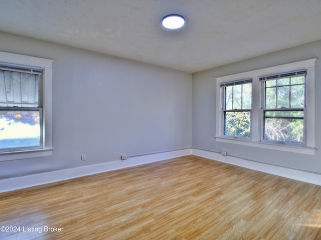 unfurnished room with light hardwood / wood-style floors