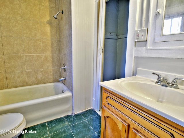 full bathroom with toilet, vanity, tile patterned floors, and tiled shower / bath