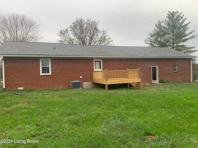 back of property featuring a lawn, central AC unit, and a deck