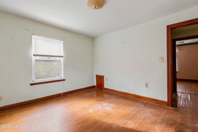 spare room featuring wood-type flooring