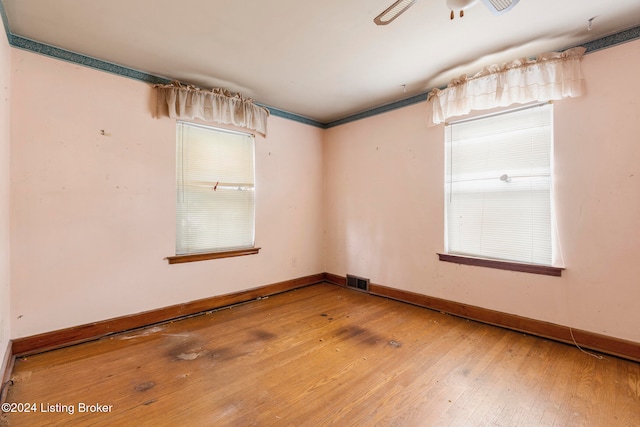 empty room featuring hardwood / wood-style floors and ceiling fan