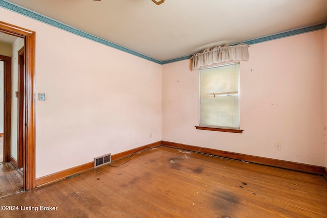 unfurnished room with hardwood / wood-style floors