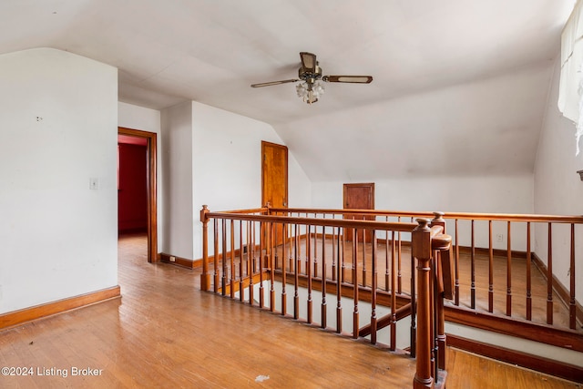 hall featuring hardwood / wood-style flooring and lofted ceiling