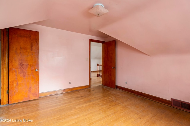 additional living space with light hardwood / wood-style flooring