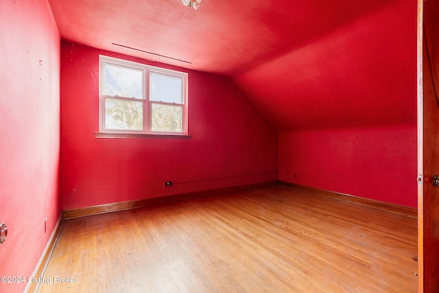 bonus room featuring light hardwood / wood-style flooring and vaulted ceiling