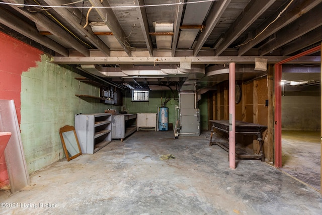 basement featuring heating unit and water heater