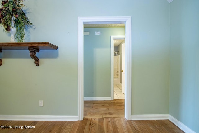 hallway with light hardwood / wood-style flooring