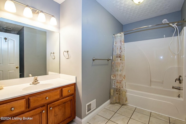 bathroom with tile patterned floors, vanity, shower / bath combo, and a textured ceiling