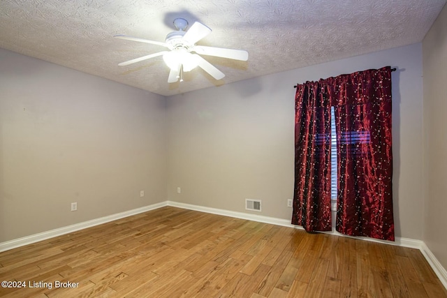 unfurnished room featuring a textured ceiling, light hardwood / wood-style flooring, and ceiling fan