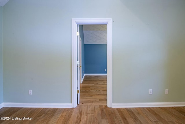 empty room with hardwood / wood-style floors