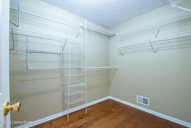 walk in closet with hardwood / wood-style floors