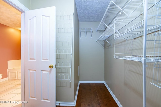 walk in closet featuring hardwood / wood-style floors