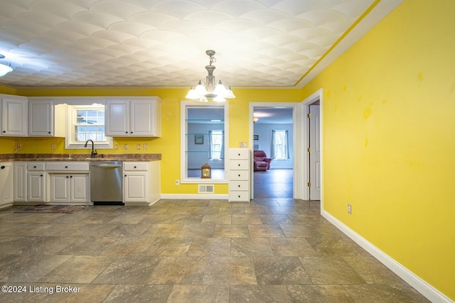 kitchen featuring sink, stainless steel dishwasher, ornamental molding, decorative light fixtures, and white cabinetry