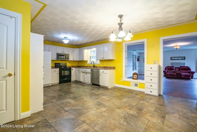 kitchen featuring white cabinetry, sink, pendant lighting, appliances with stainless steel finishes, and ornamental molding