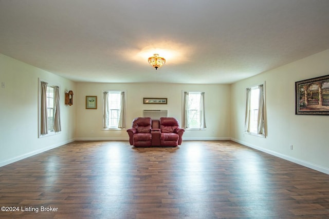 unfurnished living room with a wealth of natural light and dark hardwood / wood-style floors