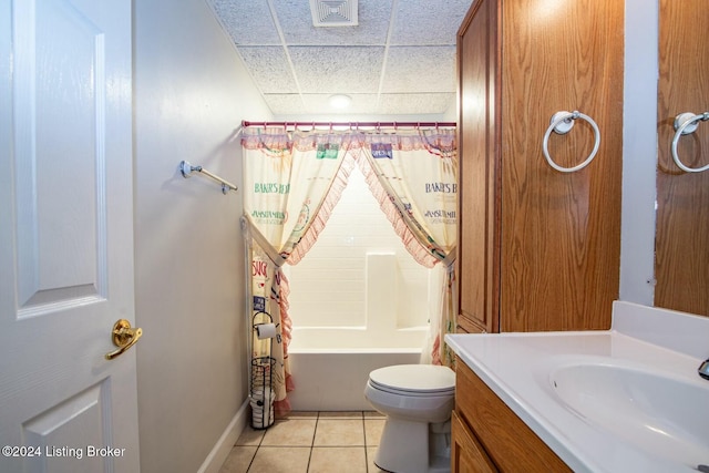 full bathroom featuring shower / bath combo, a paneled ceiling, vanity, tile patterned flooring, and toilet