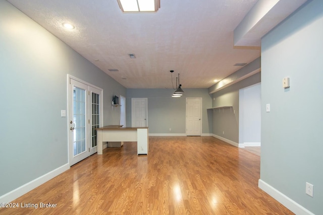 interior space with french doors and light wood-type flooring